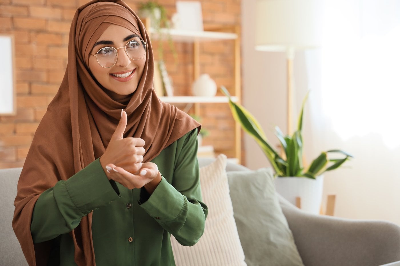 Woman in hijab giving thumbs up showing culturally safe disability support