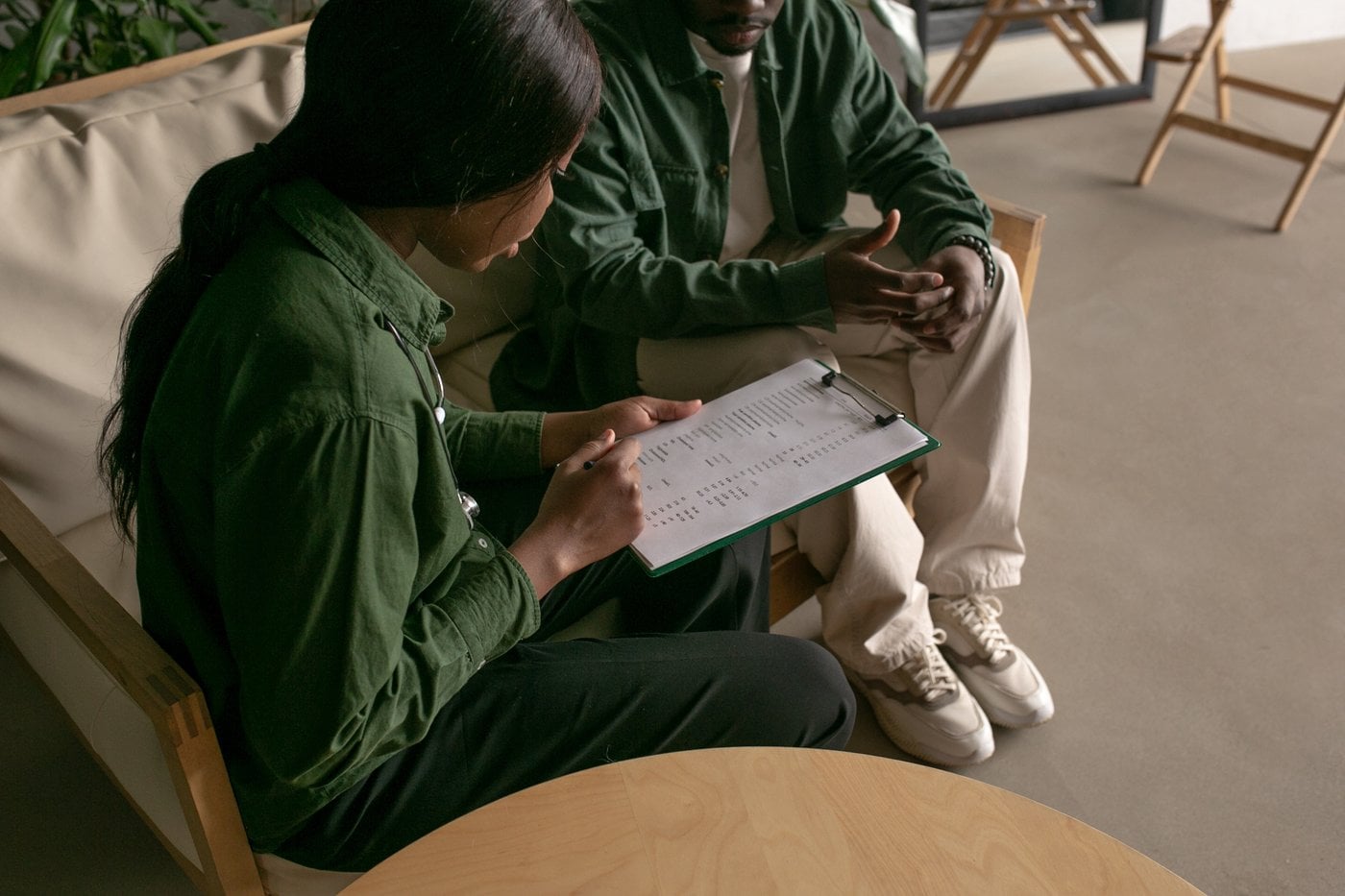 Support worker explaining documentation to a participant and their family